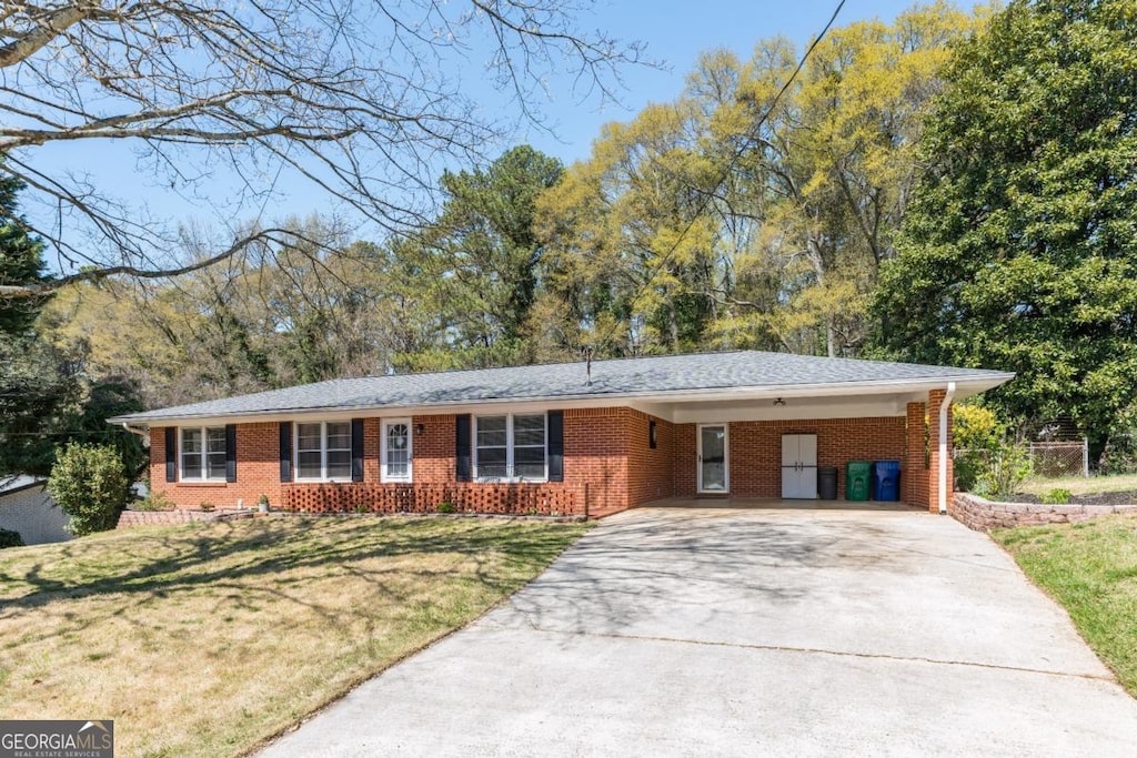 4162 Brownlee Dr, Tucker, GA 30084 - ranch-style home with driveway, brick siding, a front yard, and a carport