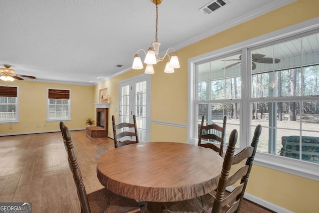 548 Sand Hill Rd, Brooklet, GA 30415 - dining room featuring wood finished floors, crown molding, baseboards, and visible vents