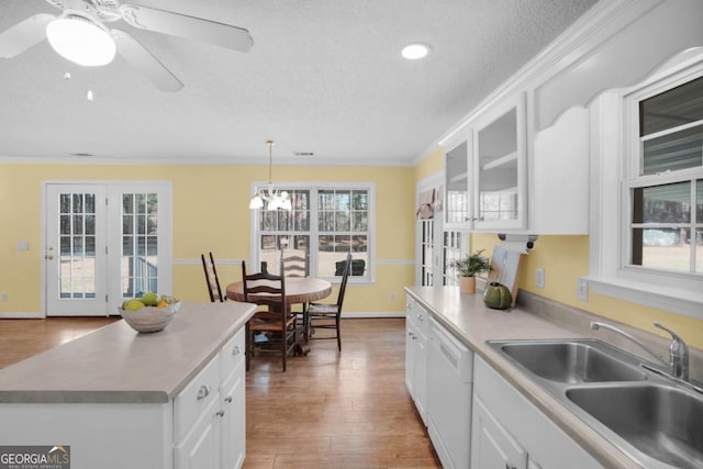 548 Sand Hill Rd, Brooklet, GA 30415 - kitchen featuring light countertops, ornamental molding, ceiling fan with notable chandelier, white fridge with ice dispenser, and wood finished floors