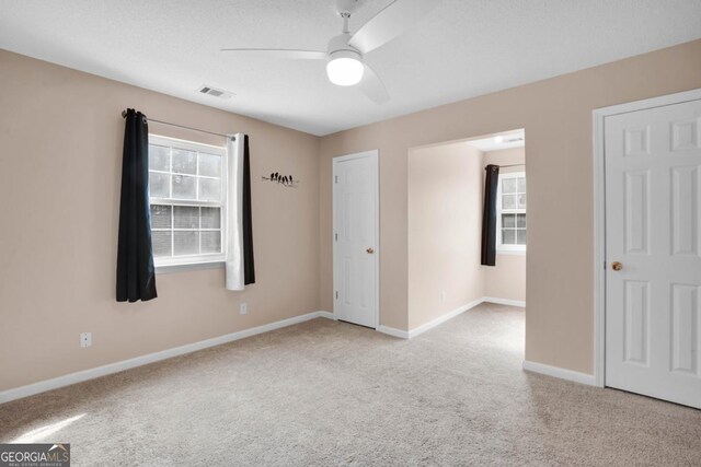 548 Sand Hill Rd, Brooklet, GA 30415 - spare room featuring ceiling fan, visible vents, plenty of natural light, and light colored carpet