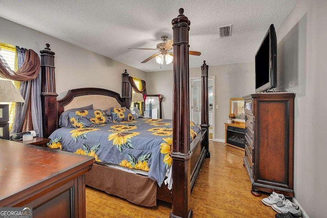104 Sugar Maple Way, Kingsland, GA 31548 - bedroom with light wood-style floors, a textured ceiling, and ceiling fan