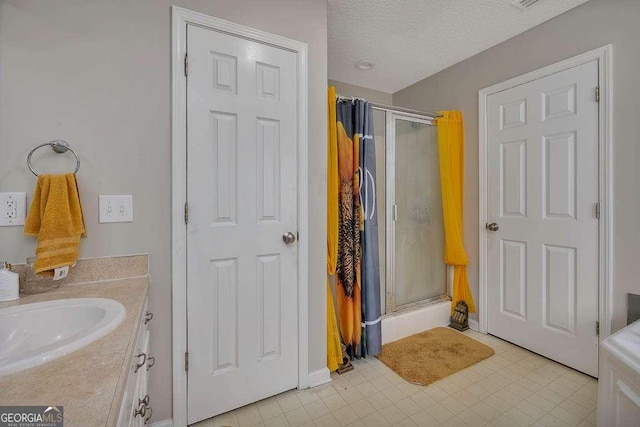 104 Sugar Maple Way, Kingsland, GA 31548 - full bath with a shower stall, vanity, tile patterned floors, a textured ceiling, and baseboards