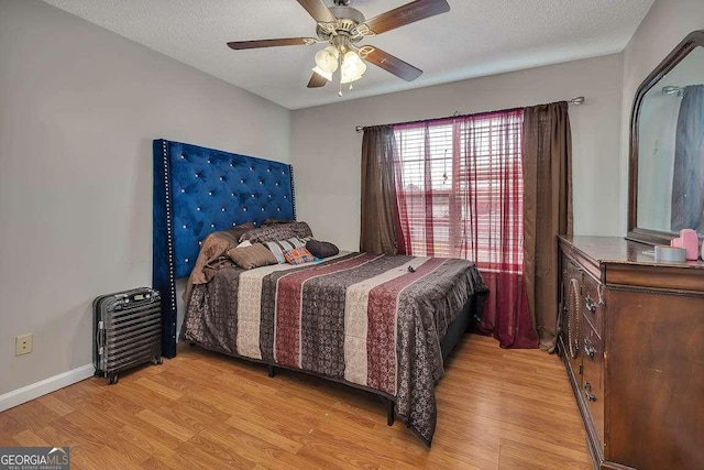 104 Sugar Maple Way, Kingsland, GA 31548 - bedroom featuring light wood-style flooring, a ceiling fan, and a textured ceiling