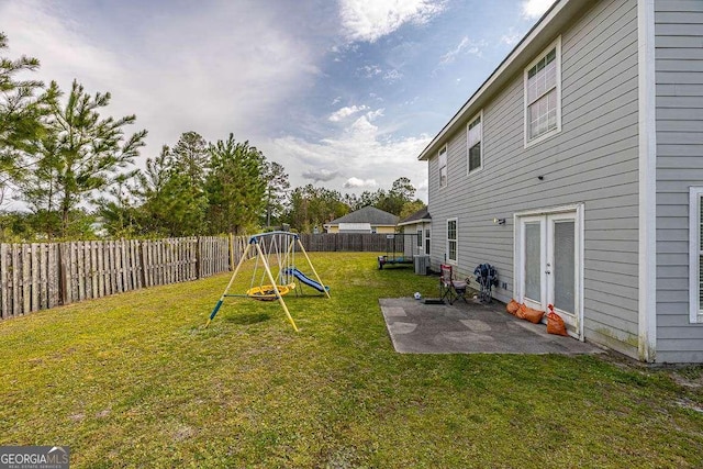 104 Sugar Maple Way, Kingsland, GA 31548 - fenced backyard with a patio and a playground