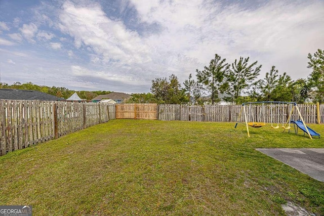 104 Sugar Maple Way, Kingsland, GA 31548 - fenced backyard featuring a playground