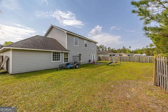 104 Sugar Maple Way, Kingsland, GA 31548 - back of house featuring a playground and roof with shingles