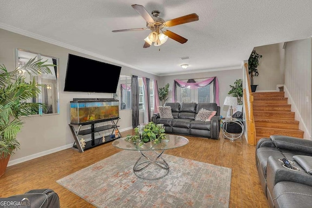 104 Sugar Maple Way, Kingsland, GA 31548 - living room with a textured ceiling, ceiling fan, wood finished floors, stairway, and crown molding
