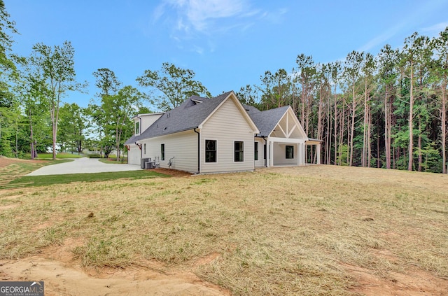 898 Bowdon Junction Rd, Carrollton, GA 30117 - rear view of property with a lawn, central AC unit, and a shingled roof
