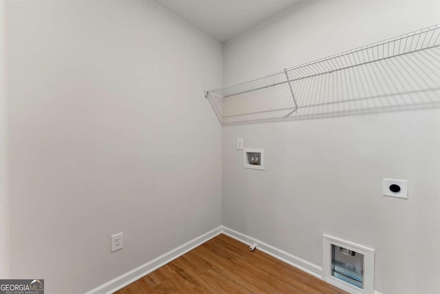 washroom featuring washer hookup, wood finished floors, hookup for an electric dryer, laundry area, and baseboards
