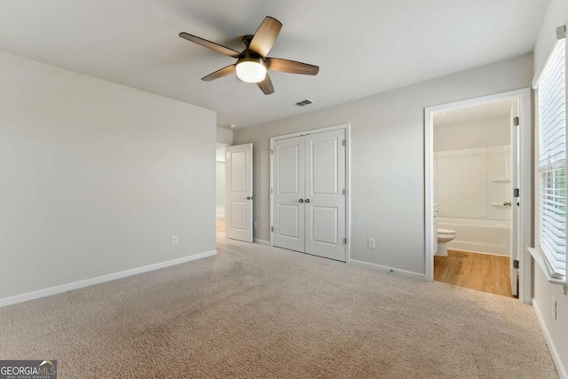 unfurnished bedroom featuring baseboards, carpet flooring, and visible vents