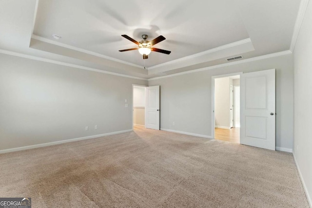 spare room with visible vents, a ceiling fan, and a raised ceiling