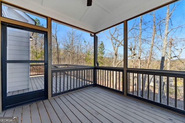 unfurnished sunroom with ceiling fan