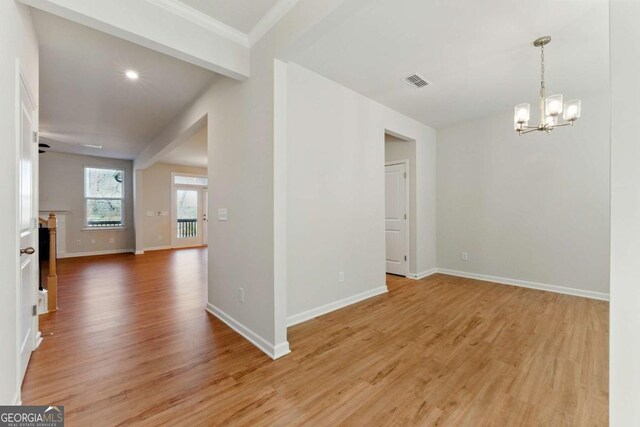 interior space with an inviting chandelier, baseboards, light wood finished floors, and visible vents