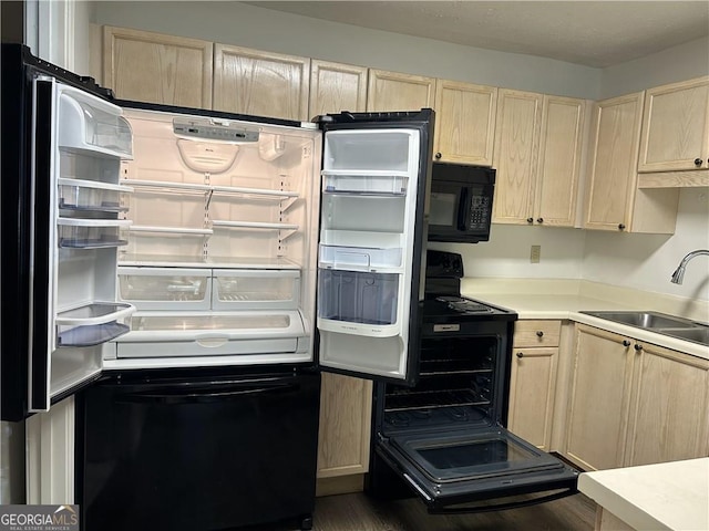 112 Bentley Pl, Tucker, GA 30084 - kitchen with a sink, black appliances, light countertops, and light brown cabinetry