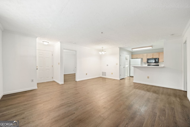 112 Bentley Pl, Tucker, GA 30084 - unfurnished living room featuring a chandelier, wood finished floors, and a textured ceiling