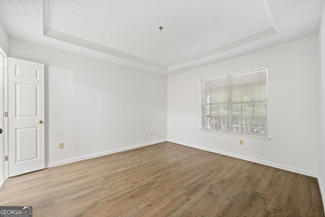 112 Bentley Pl, Tucker, GA 30084 - spare room with baseboards, wood finished floors, and a raised ceiling