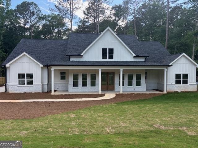 502 Camp Lake Rd, Monroe, GA 30655 - modern inspired farmhouse featuring board and batten siding, roof with shingles, and a front yard