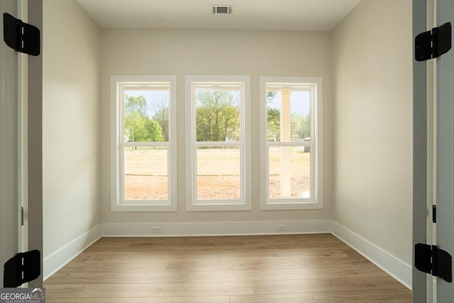 502 Camp Lake Rd, Monroe, GA 30655 - empty room featuring healthy amount of natural light, light wood finished floors, and baseboards