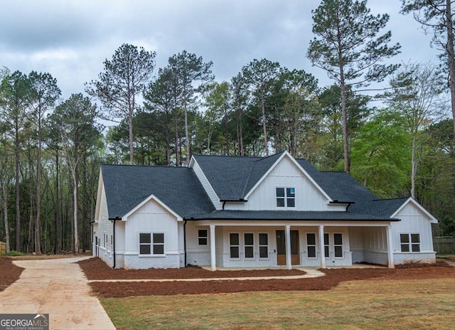 502 Camp Lake Rd, Monroe, GA 30655 - modern inspired farmhouse featuring board and batten siding, concrete driveway, a shingled roof, covered porch, and a front lawn