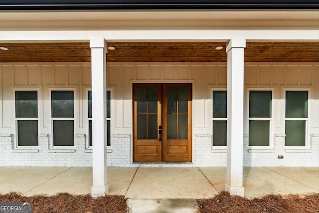 502 Camp Lake Rd, Monroe, GA 30655 - doorway to property with board and batten siding, french doors, and brick siding