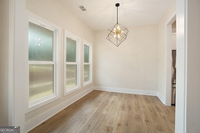 502 Camp Lake Rd, Monroe, GA 30655 - unfurnished room featuring light wood-style floors, baseboards, and a chandelier