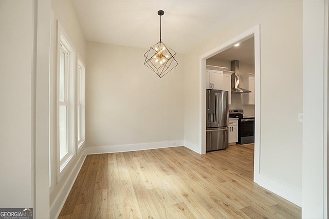 502 Camp Lake Rd, Monroe, GA 30655 - unfurnished dining area with light wood-type flooring and baseboards
