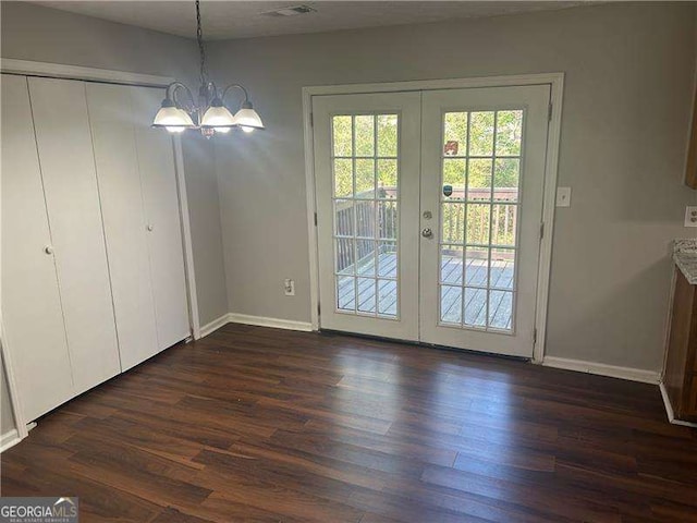 2039 Corners Cir, Lithonia, GA 30058 - unfurnished dining area with french doors, dark wood finished floors, and a chandelier