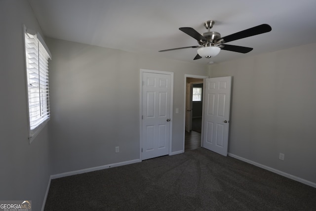 619 Church St NW, Atlanta, GA 30318 - empty room featuring baseboards, dark colored carpet, and ceiling fan