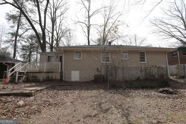 1923 Rosewood Rd, Decatur, GA 30032 - back of house featuring brick siding, fence, central AC unit, and a deck