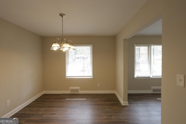 1923 Rosewood Rd, Decatur, GA 30032 - unfurnished dining area featuring dark wood-type flooring, visible vents, and an inviting chandelier
