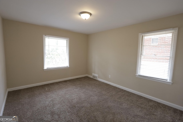 1923 Rosewood Rd, Decatur, GA 30032 - spare room featuring baseboards, visible vents, carpet floors, and a healthy amount of sunlight