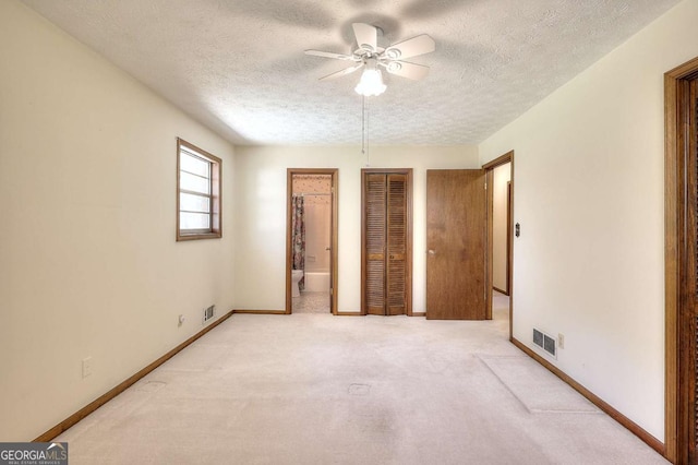 unfurnished bedroom featuring baseboards, visible vents, and a textured ceiling