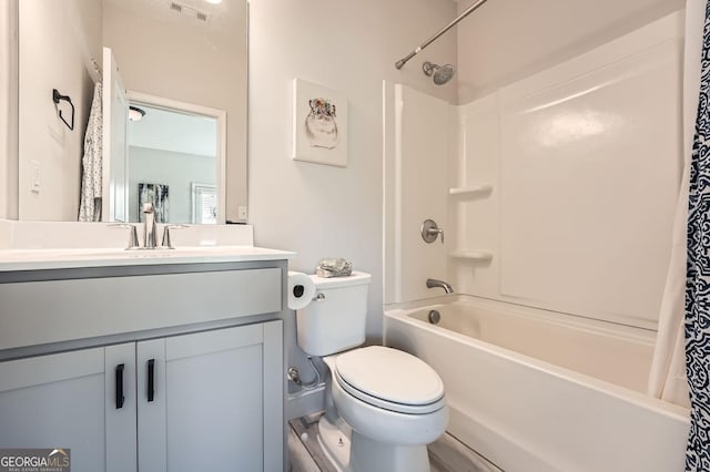 full bath with visible vents, toilet, shower / tub combo, and vanity