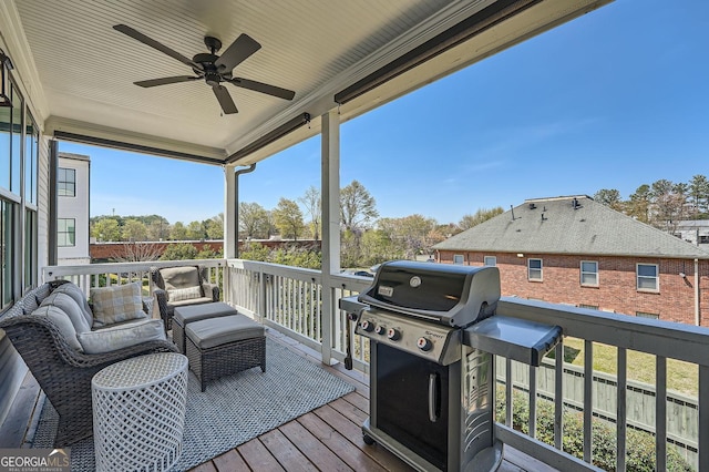 wooden terrace featuring a grill and a ceiling fan