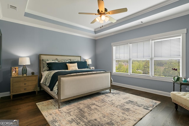 bedroom featuring baseboards, visible vents, dark wood-type flooring, and a raised ceiling