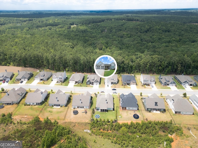 drone / aerial view with a view of trees and a residential view