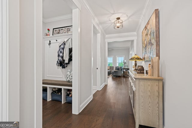 hall featuring baseboards, crown molding, and dark wood-style flooring