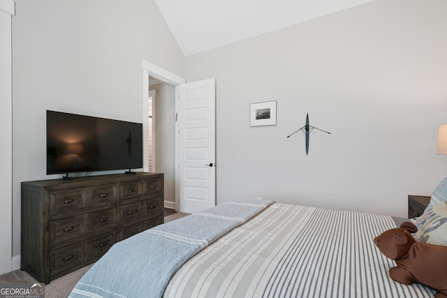 bedroom featuring baseboards, lofted ceiling, and carpet floors