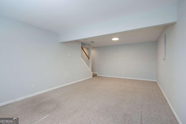 finished below grade area with stairs, carpet, and baseboards