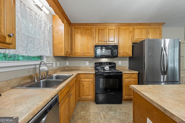 104 Nugget Ln, Ellijay, GA 30540 - kitchen with black appliances, a sink, light countertops, a textured ceiling, and brown cabinetry