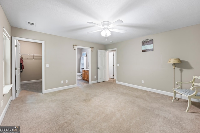 104 Nugget Ln, Ellijay, GA 30540 - unfurnished bedroom with light carpet, a spacious closet, baseboards, ceiling fan, and ensuite bathroom