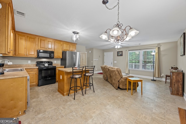 104 Nugget Ln, Ellijay, GA 30540 - kitchen featuring black appliances, a sink, a chandelier, light countertops, and open floor plan