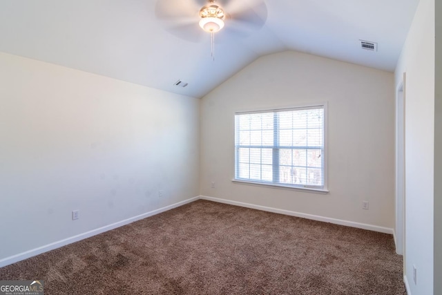 carpeted empty room with baseboards, lofted ceiling, ceiling fan, and visible vents