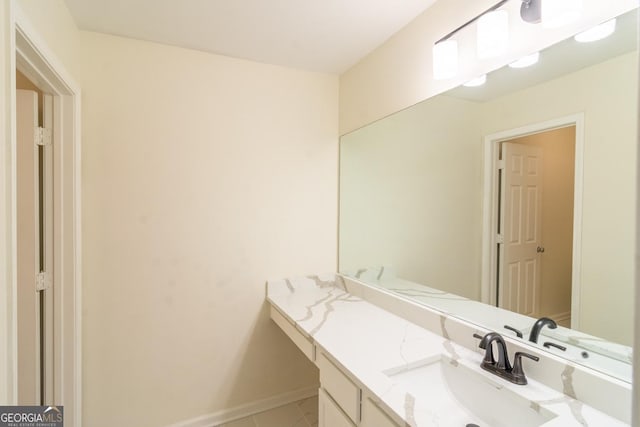 bathroom featuring baseboards, tile patterned floors, and vanity