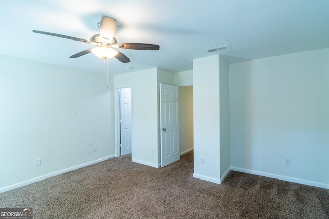 unfurnished bedroom featuring carpet flooring, baseboards, ceiling fan, and visible vents