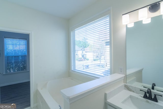bathroom featuring vanity and a garden tub