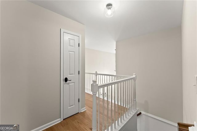 5055 Hamptons Club Dr, Alpharetta, GA 30004 - hall with an upstairs landing and wood finished floors