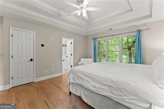 5055 Hamptons Club Dr, Alpharetta, GA 30004 - bedroom with a raised ceiling, crown molding, wood finished floors, ensuite bathroom, and ceiling fan
