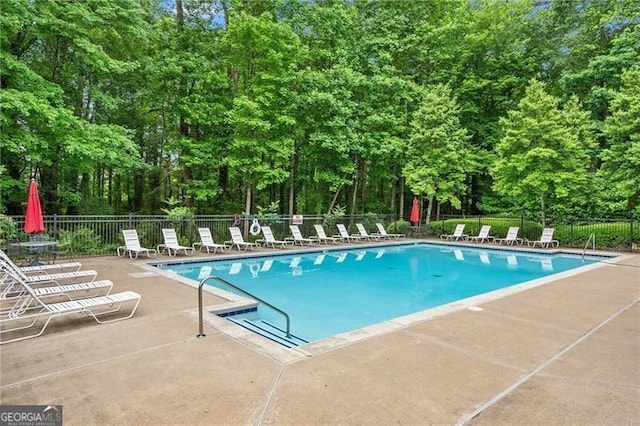 5055 Hamptons Club Dr, Alpharetta, GA 30004 - community pool with a patio and view of wooded area