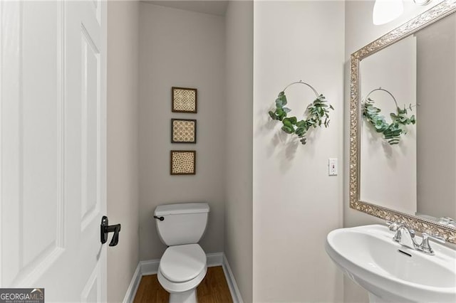 5055 Hamptons Club Dr, Alpharetta, GA 30004 - half bathroom featuring a sink and wood finished floors